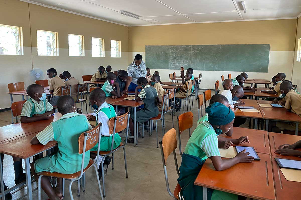 Teacher supporting students with classroom technology