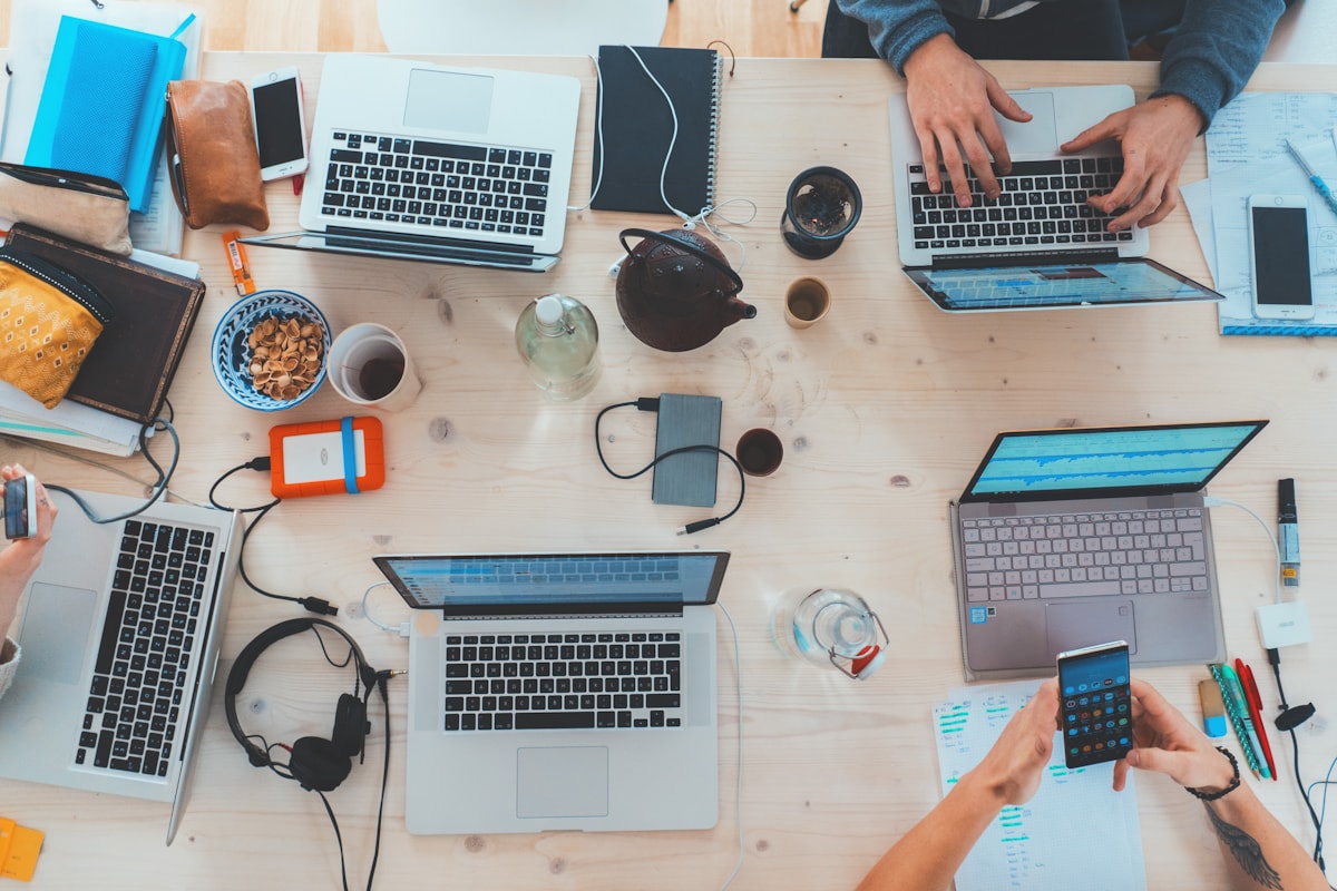 Team working with laptops in an open workspace
